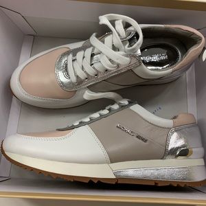 Pink and tan Michael Kor’s tennis shoes